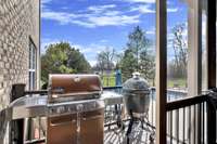 Off the kitchen and porch is a special grilling station overlooking the pool and backyard.
