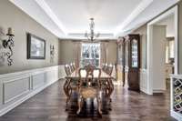 A formal dining room off the kitchen can accommodate a large gathering with elegant millwork and graceful lighting.