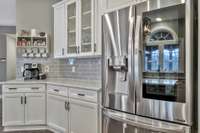Cabinets with storage galore and space for a coffee station as well as a top of the line LG fridge.