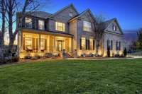 Custom outdoor lighting, mature landscaping, a curved sidewalk and a welcoming front porch with columns make this a wonderful home.