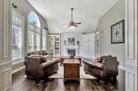 Beauty abounds in this great room with vaulted ceilings surrounded in gorgeous custom millwork and built in cabinetry.  A wall of windows with custom plantation shutters allows for an abundance of natural light.