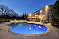 Lighting by the pool illuminates the beautiful back yard while allowing for late night swimming!