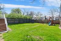 The expansive flat fenced-in yard offers many uses, including alley access for a future DADU/garage