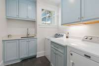 With its folding counter and convenient sink, laundry becomes a breeze amidst the beauty of this space