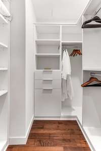 Custom walk in closets with copious shelving and hanging options with drawers for necessities and jewelry