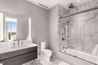 Floor to ceiling marble, floating cabinetry, back lit mirrors and tub/shower combo