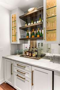 You are immediately greeted with an invitation that is hard to pass up. Make yourself a drink at the custom bar, complete with paneled wine cooler and ice maker
