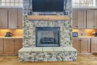 Fireplace with built in cabinets and granite countertops.