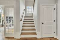 Stairs leading to 2nd floor with storage closet.