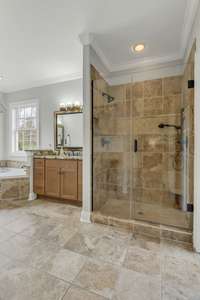 Primary bath with separate tiled shower and jetted tub.  2 separate vanities.