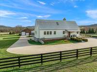 A look at the front entrance to the home shows the extra wide 16' concrete driveway (most homes only have 12' wide) and even was widened on the turn to 23' to accommodate large RV's.