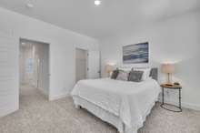 Primary Bedroom with Walk-in Closet and Ensuite Bathroom. (Photo is of previous townhome built. It is the same floor plan, but interior finishes may vary).