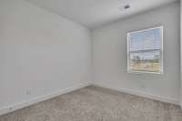 Bedroom #2 Upstairs. (Photo is of previous townhome built. It is the same floor plan, but interior finishes may vary).