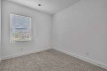 Bedroom #3 Upstairs. (Photo is of previous townhome built. It is the same floor plan, but interior finishes may vary).