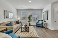 Very Open Living Room Area. (Photo is of previous townhome built. It is the same floor plan, but interior finishes may vary).