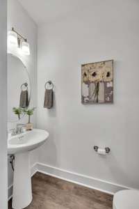 Half Bath/Powder Room Located Conveniently on the First Floor. Bathroom Mirror will not convey.(Photo is of previous Townhome built. It is the same floor plan but interior finishes may vary).