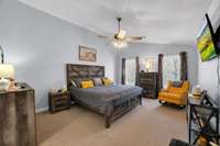 Big master bedroom with a sitting area .