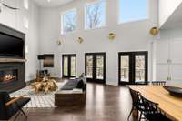 Elevated ceilings and windows above patio doors flood this room with natural light.