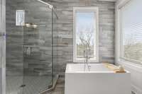 Enjoy modern finishes and fixtures in the master bath nestled amongst the trees.