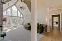 Living room and hall leading to downstairs primary bedroom.