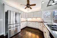 Kitchen is equipped with stainless steal appliances, pot holder, and trash compactor