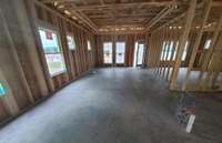 This listing is at "ground stage" - photos are of the same plan under construction - dining & living room