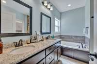 The primary bathroom boasts a luxurious double vanity sink adorned with sleek granite countertops! 1133 Corona Ct   Lascassas, TN 37085