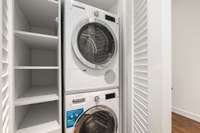 A brand-new washer and dryer set is nestled away in its own closet with additional, curated storage space.