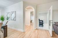 Archway leads to Master with laundry room on left. Right door leads to sunroom