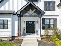 *Covered front porch with a sidewalk that leads to the side entry garage*