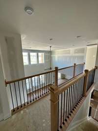 Catwalk upstairs looking over to the light filled Family Room. Pictures are of another Leighland  floorplan in a different community, finishes may be different.