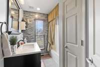 Beautifully remodeled hall bathroom with a linen closet and shower/tub combo.