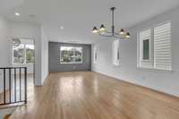 Dining room with custom lighting and hardwoods