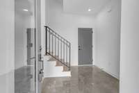 Polished concrete floors in entryway and throughout the ground floor.