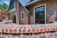 A side view showing the front patio which details the Tudor design.