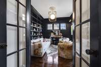 Just off the foyer, French doors lead to a handsome library/office