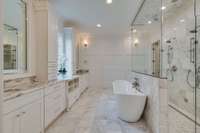 Spa inspired Primary Bath has double vanities, a soaking tub and steam shower