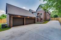 The electric gate at right opens to a large driveway which leads to a 3 bay garage