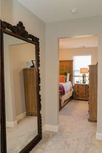 Off the staircase leading upstairs, you will find 3 additional bedrooms as this hallway leads directly to the primary suite.