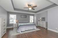 Welcome to your primary suite with an abundance of space!  There is a nook for your dresser, armoire, built ins, etc   No carpet throughout this entire home!  Ceiling fan, plenty of sunlight and wall space to make this your oasis.