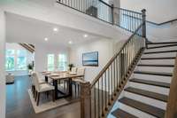 Virtually Staged - Showcasing the dining room, the gorgeous staircase leading to the upstairs bonus room, and the covered outdoor patio