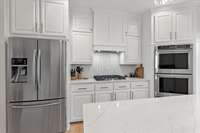 Gas cooktop, double ovens, diswasher are all KitchenAid with a built-in Vent Hood