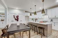 Chefs kitchen with custom lighting and stunning island