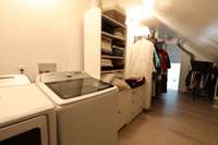 "secret room" hidden behind custom cabinetry in primary bath with ANOTHER laundry and more storage