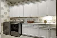 Very Large laundry with lots of storage and custom cabinets