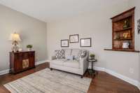 Alternate view of front left room, currently used as a home office and secondary living space.  Note additional built in book shelving and neutral wall colors.