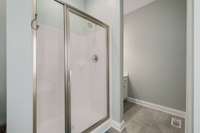 Alternate view of main floor owner's ensuite shower, and second vanity.  Here you can see the replacement tile flooring too.