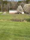 Home has large fenced back yard with a small creek running behind fence.