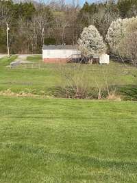 Home has large fenced back yard with a small creek running behind fence.