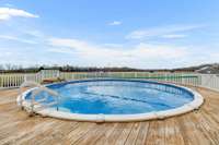 The listing features a 35' above ground pool complemented by a spacious wooden deck built around it! The backyard is securely fenced in, ensuring privacy and safety for leisure and relaxation.  2491 Taylor Ln  Eagleville, TN 37060